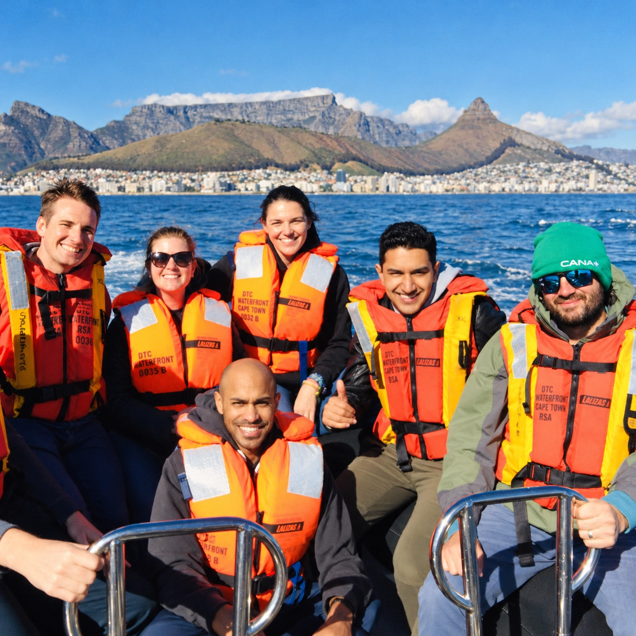 People on a boat wearing orange life jackets.